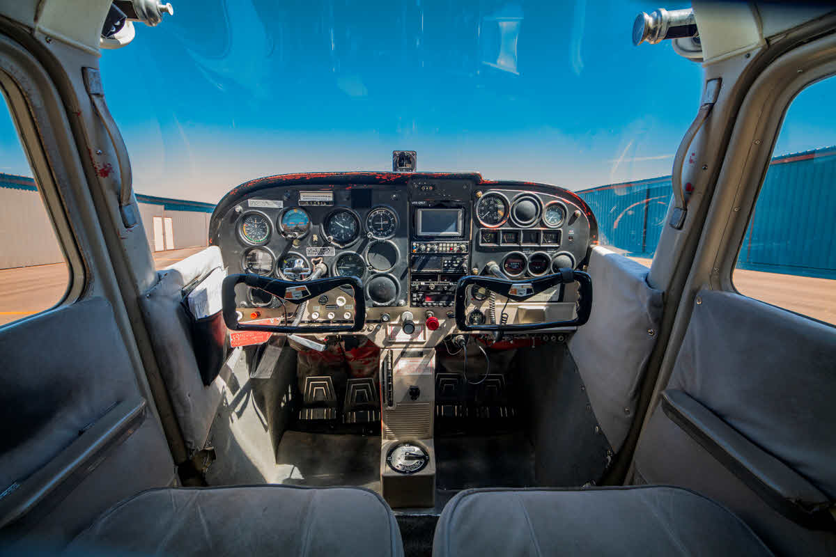 Interior view of plane controls and instrument panel.